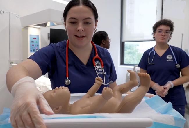 Simmons nursing students working in the pediatric section of the simulation lab