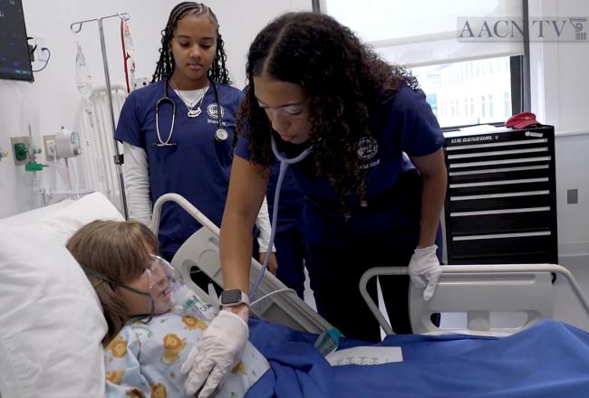 Nursing students working with the young simulation patient in the Simmons simulation center