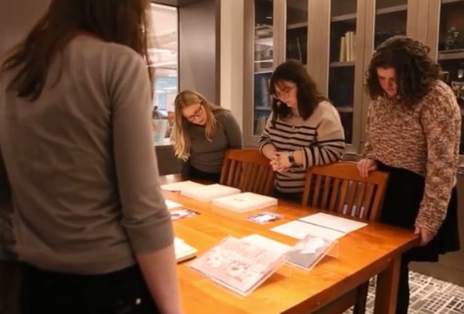 SLIS master's degree students looking at archival materials