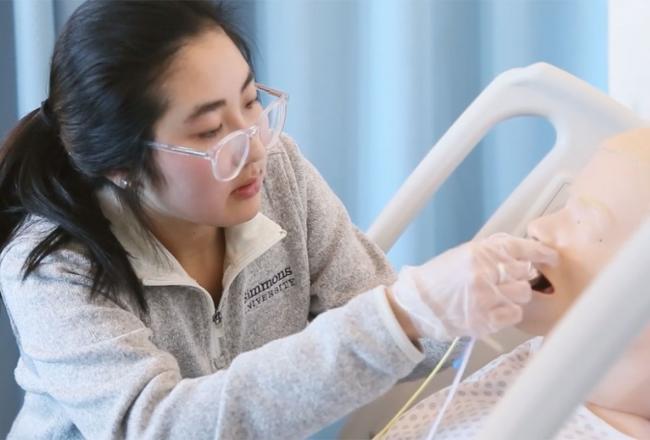 A nutrition student working in the simulation lab