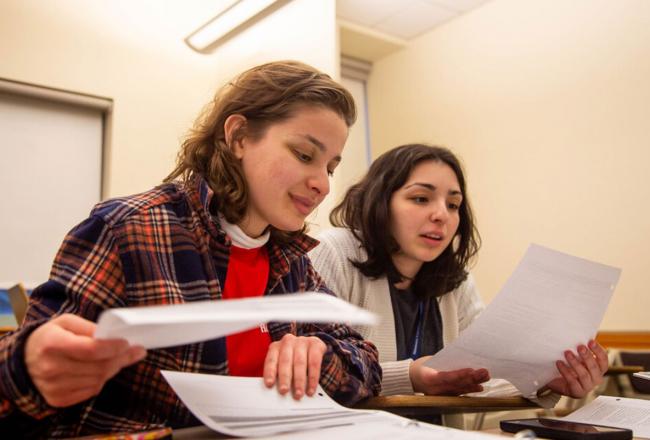 Two Simmons Behavior Analysis students comparing notes