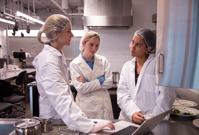 Three Simmons students working in the pigments lab