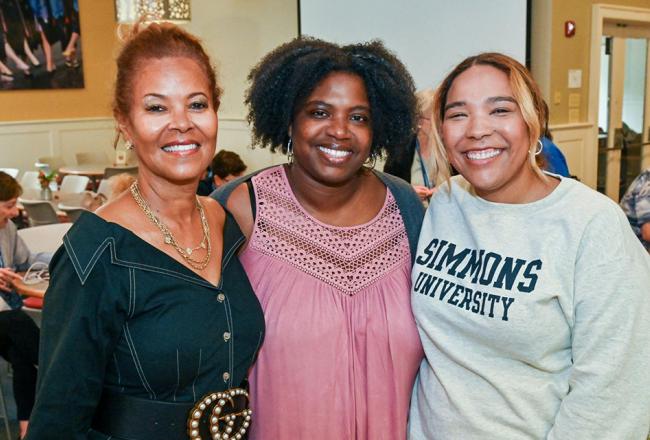 Three alums smiling together