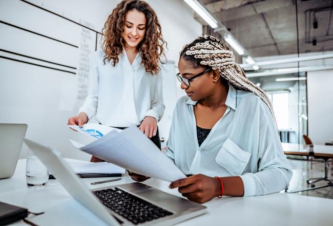 Two women working on a project at a desk