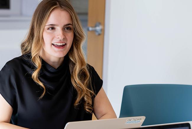 Management Student sitting at computer
