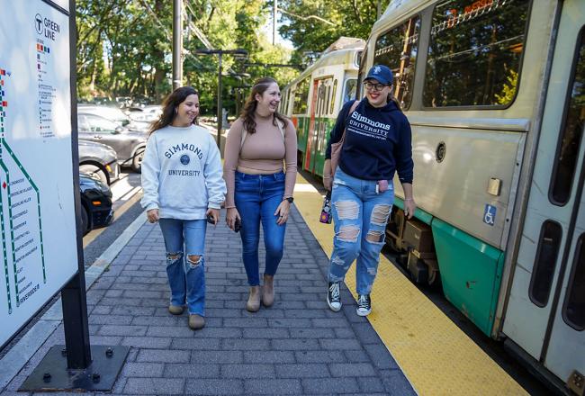 Three Simmons students at a Boston T station