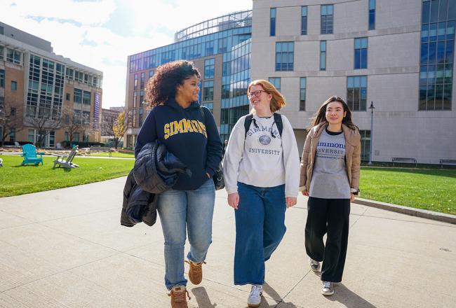 Three undergraduate students walking on the campus of Simmons University