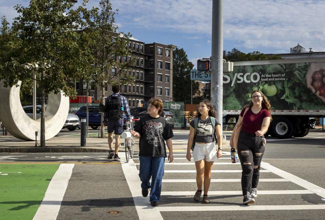 Three Simmons students walking in a crosswalk in Boston