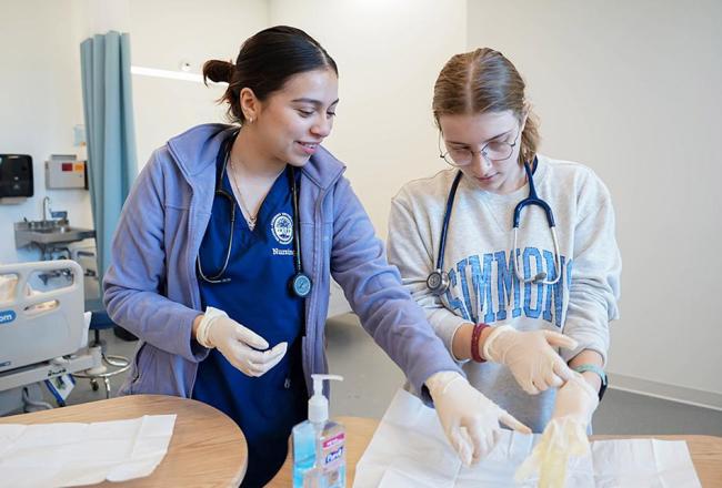 Two nursing students in classroom lab