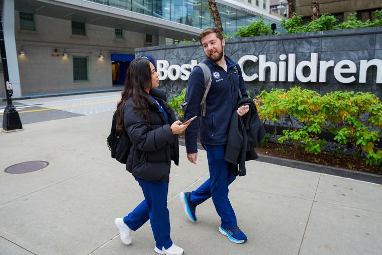 2 Simmons nursing students talking as they walk past the Boston Children's Hospital