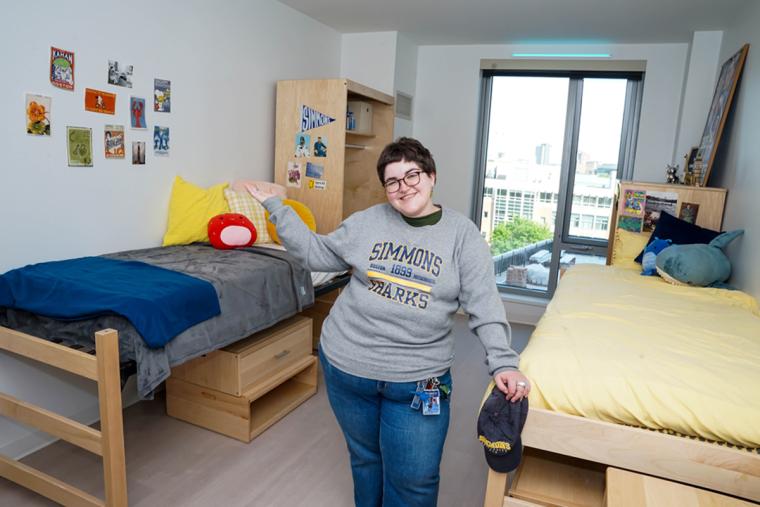 A student showing off a room in the Living Learning Center