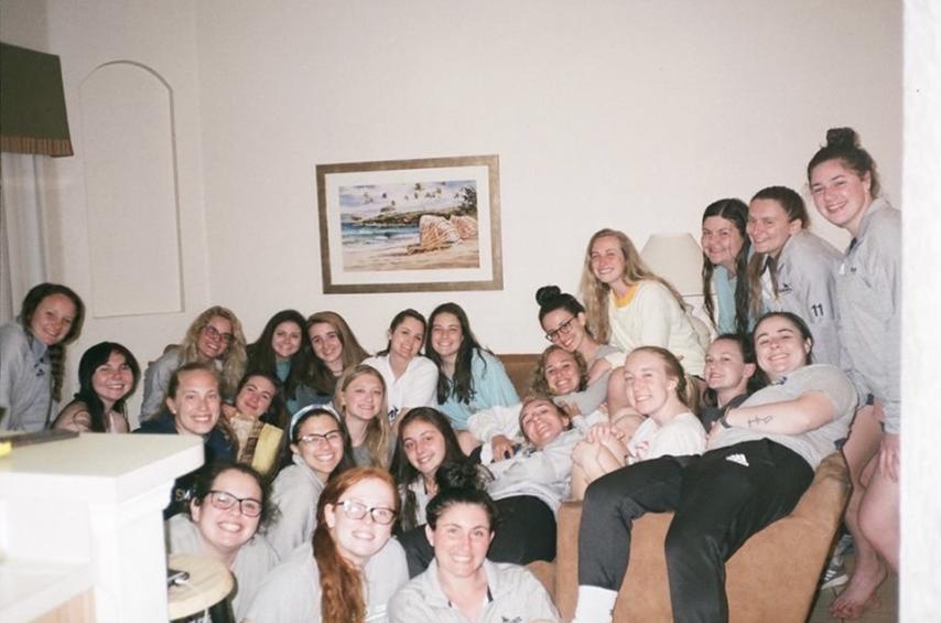 Simmons University lacrosse team hanging out together.