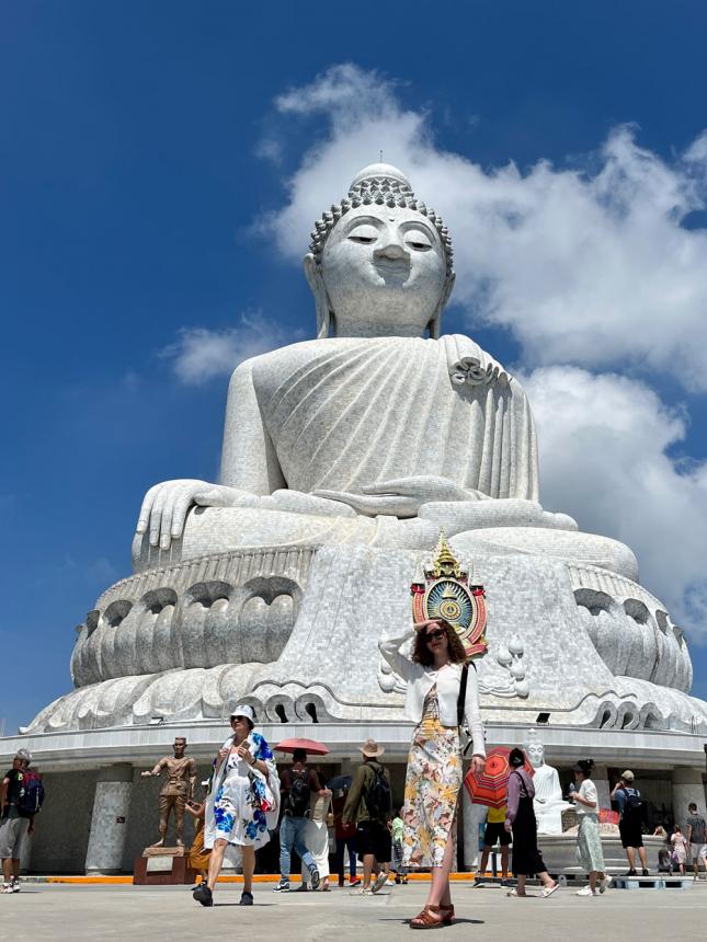 Lauren Murphy in front of a large Buddha in Phuket, Thailand