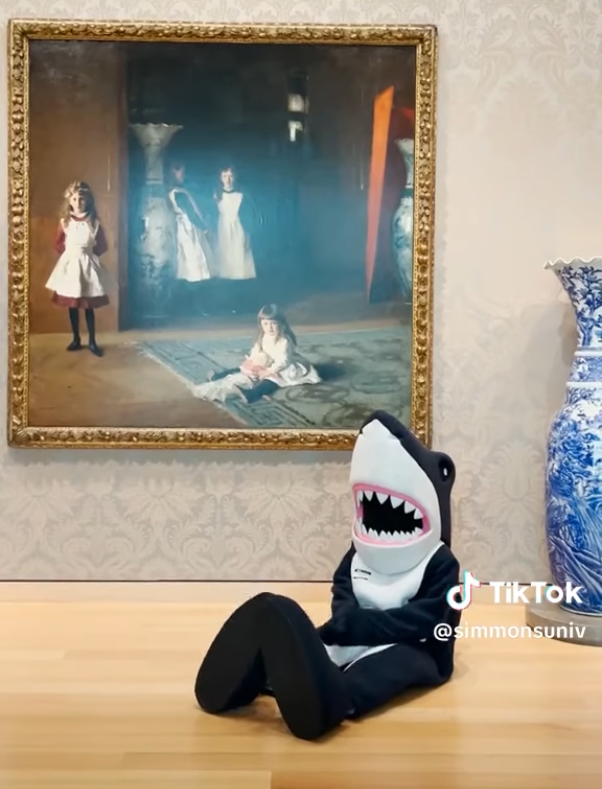 Stormy sitting on the floor in front of a large painting at the Museum of Fine Arts in Boston