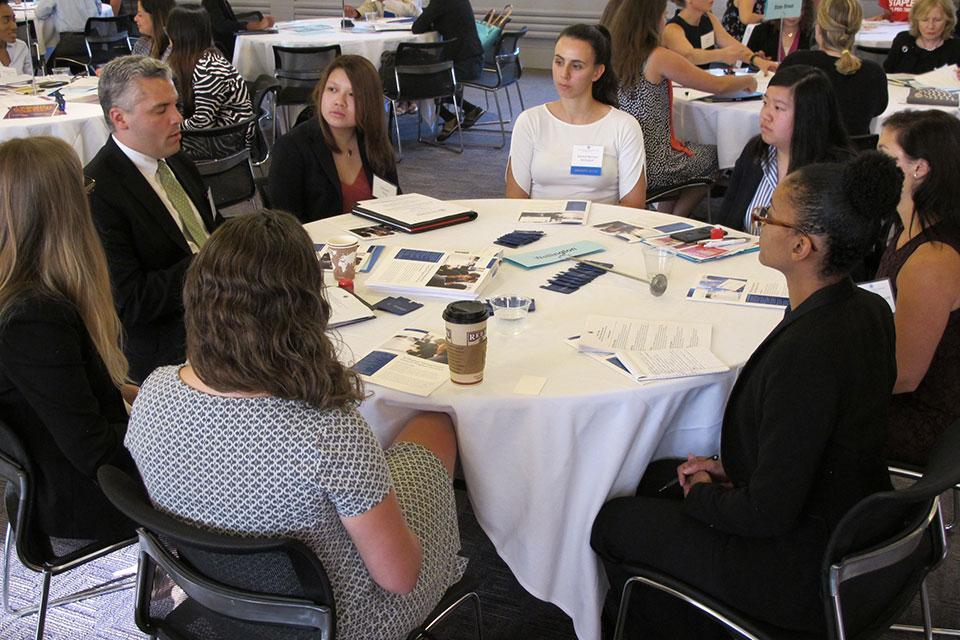 People in discussion around a table.