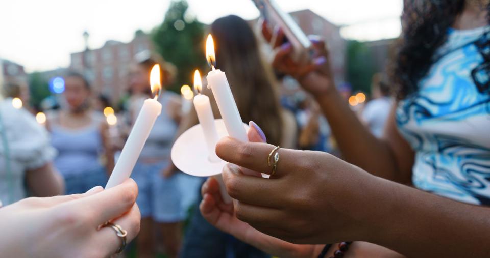 Students lighting candles at the candle lighting ceremony