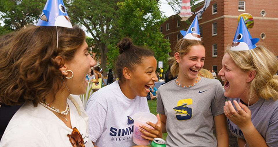 students laughing in shark hats on res quad