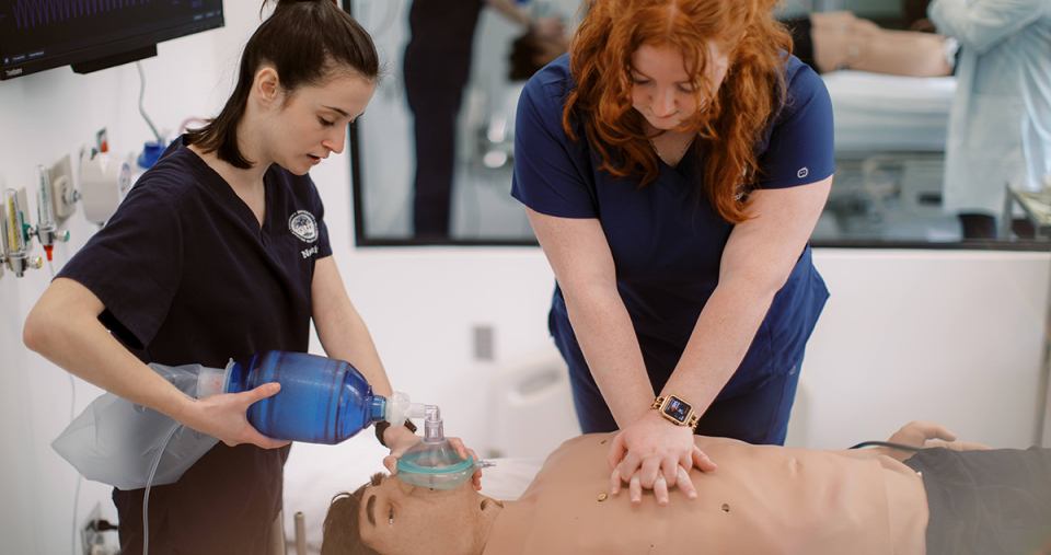 Students simulating giving CPR to a patient in the Nursing Simulation Center