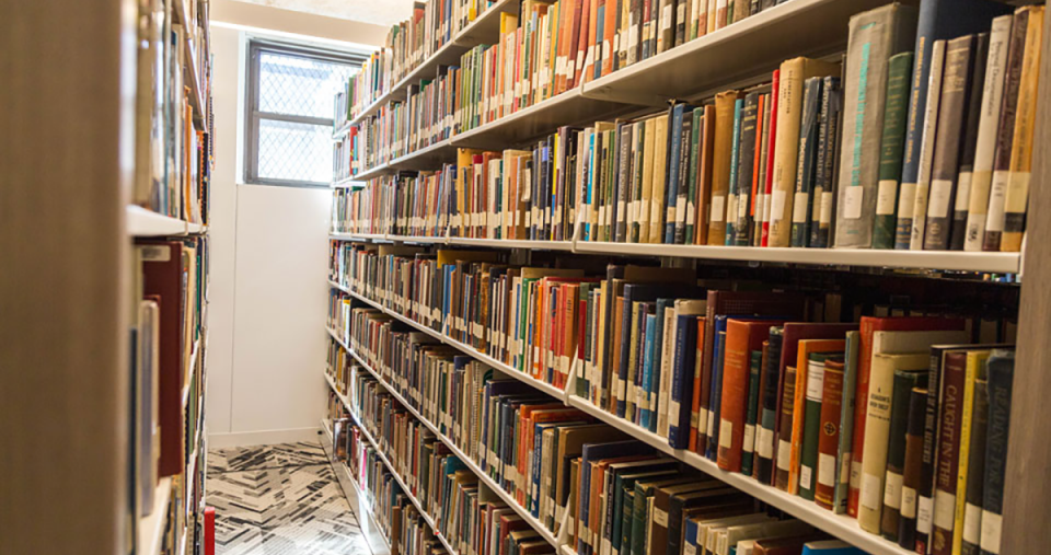 A row of books in the Simmons University library
