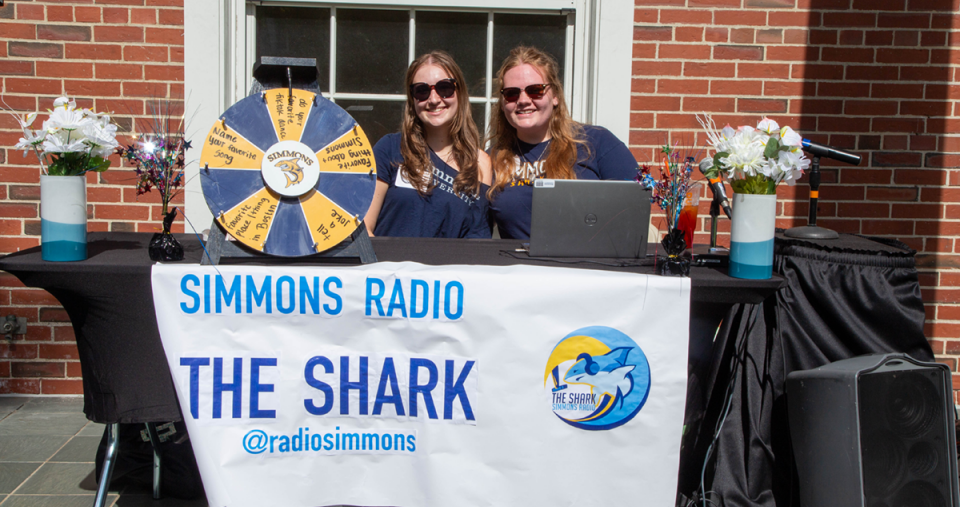 Students at a table for Simmons Radio, "The Shark" during Orientation weekend 2024