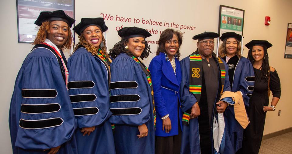 Doctoral Graduates lined up with President Wooten and others 