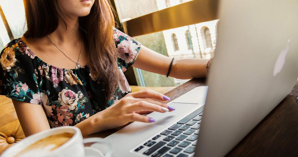 A student working on a laptop with a cup of coffee on their desk. Image by Pexels from Pixabay.