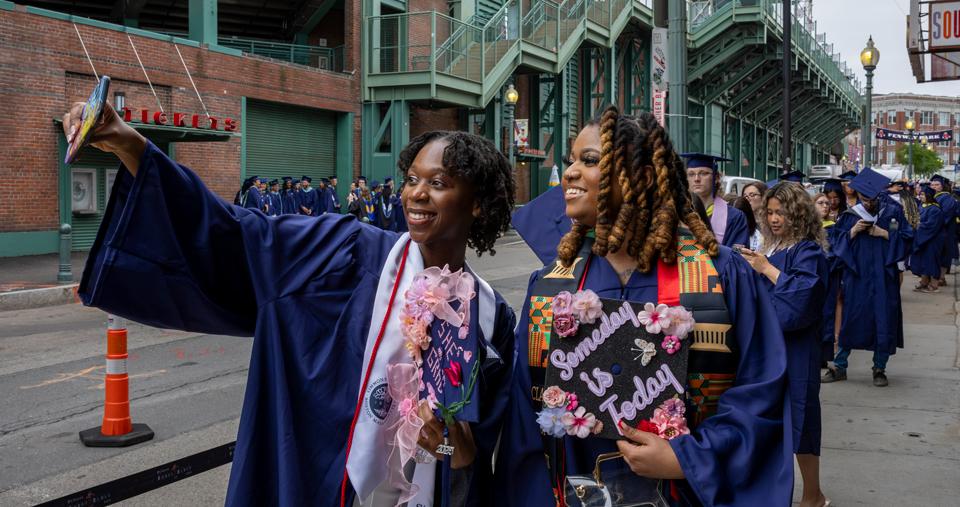 Many students lined up near Fenway Park to process into Commencement