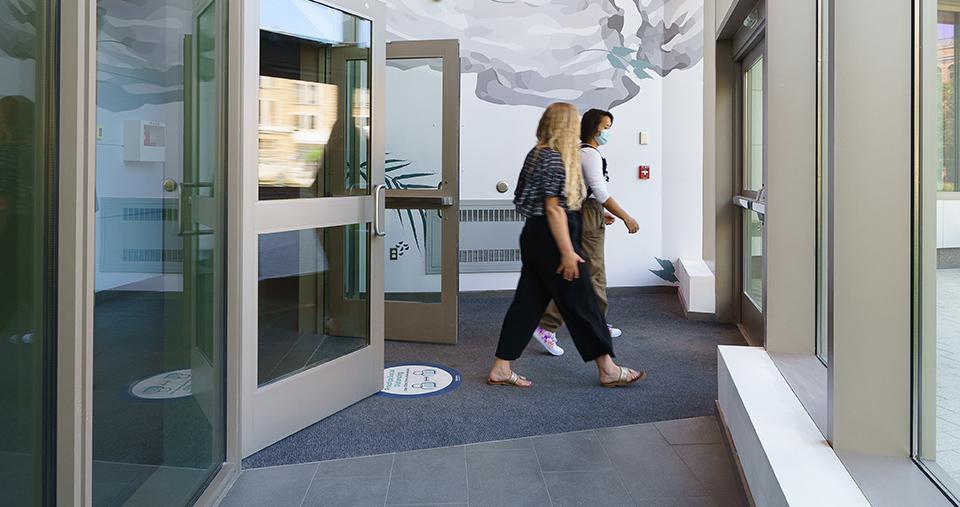 People walking through doorway of Simmons Building