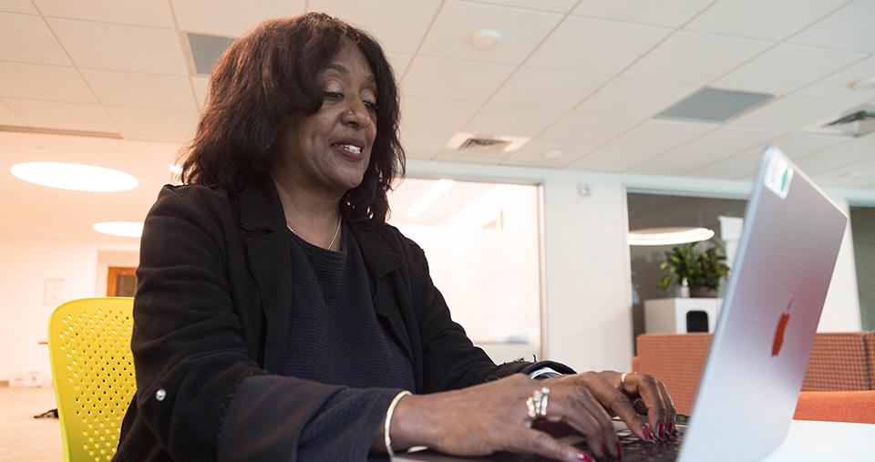 Woman typing on laptop computer