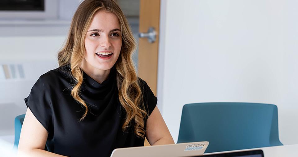 Management Student sitting at computer