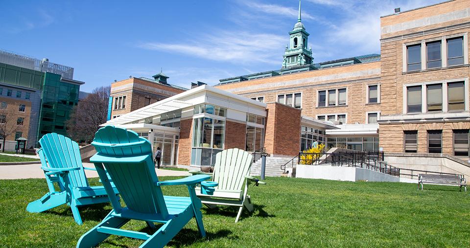 Simmons Campus in the spring. Chairs on grass in quad.