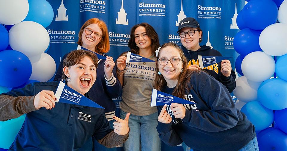Studens posing at selfie station with Simmons swag