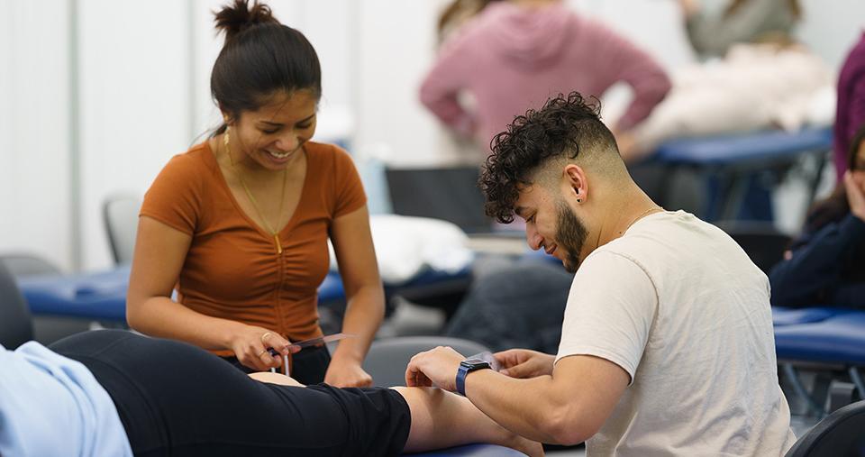 Physical Therapy students working together on patient