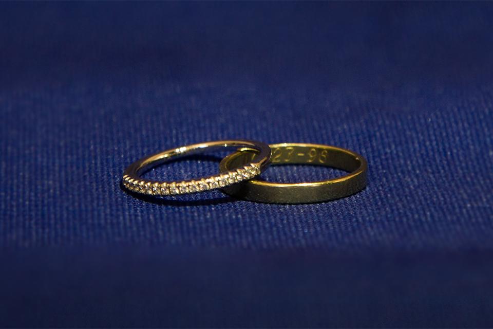 Two wedding rings on a blue background