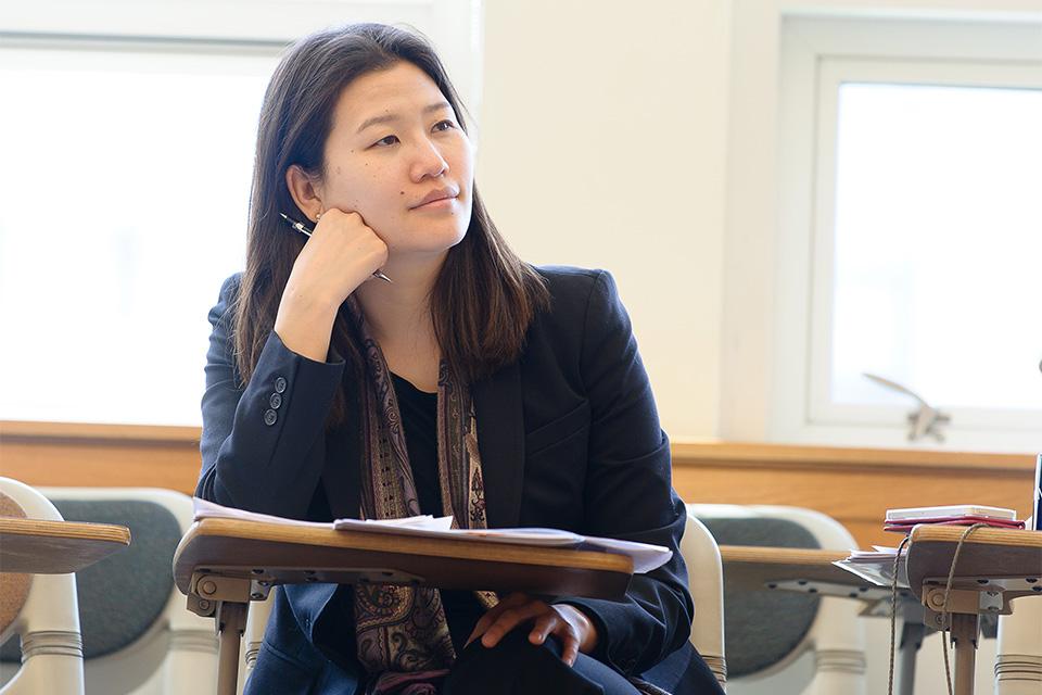 Kyong Eun Oh listening in a classroom.