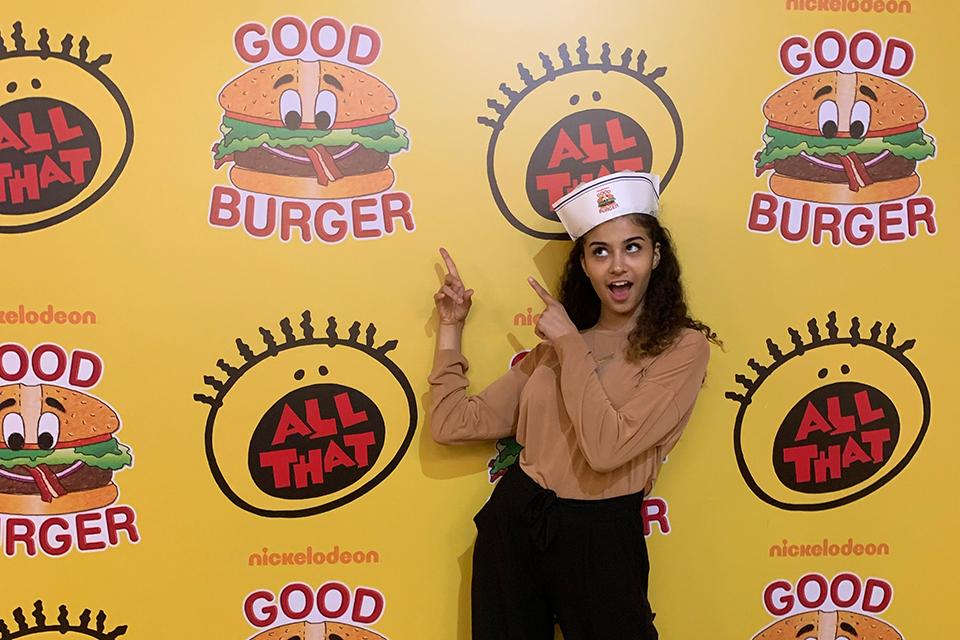 Yasmine Ebeed standing in front of a media wall