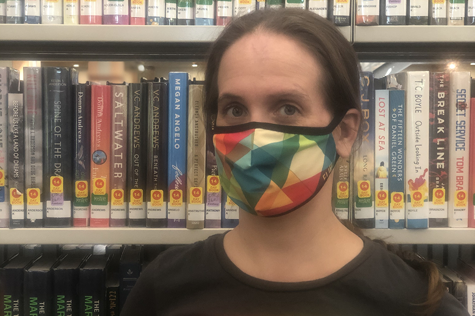Kate Leppanen wearing a mask in the library