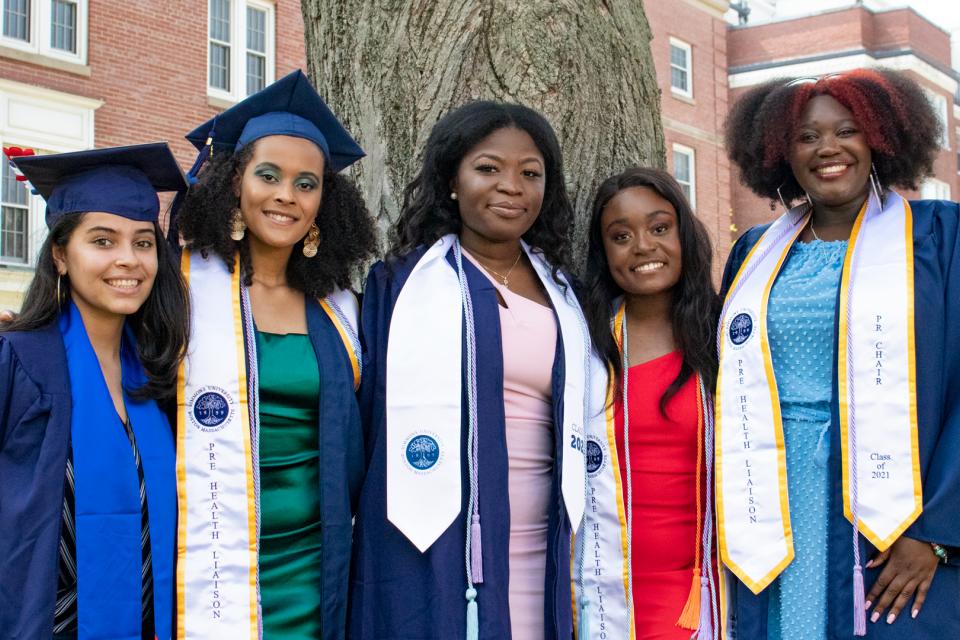 Students in caps and gowns at Simmons University
