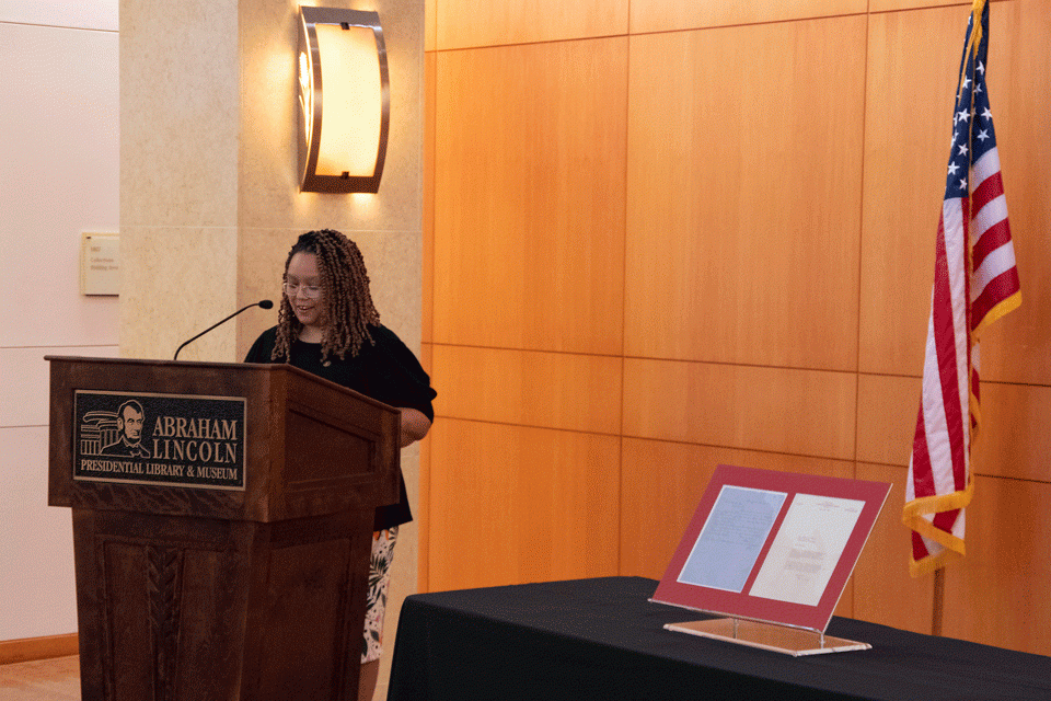 Christina Shutt showcasing a recent donation of a letter written by Lincoln to his friend, Elihu Powell.