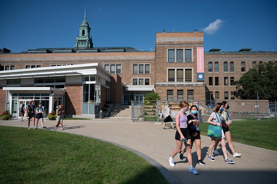 Students walking during orientation 2022 in main quad heading with MCB/Fens in background