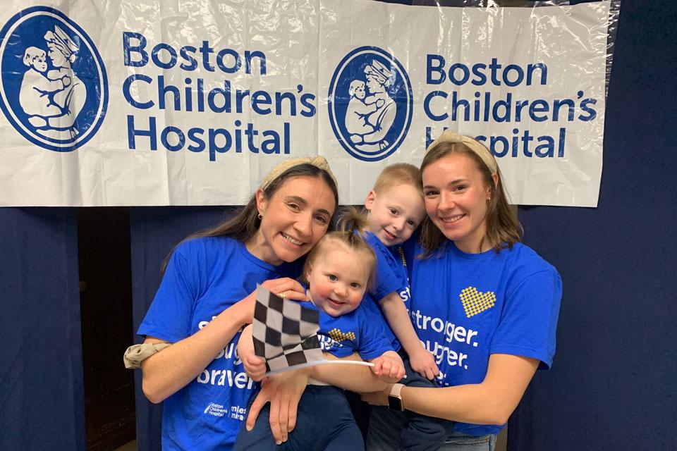 Olivia Panagiotou ’23 and Kaitie Panagiotou ’18 holding two small children